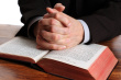 ist1_11592620-praying-hands-on-an-open-bible.jpg